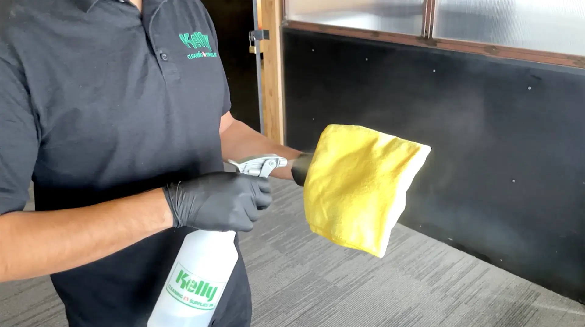 Kelly Cleaning crew member using a Kelly spray bottle